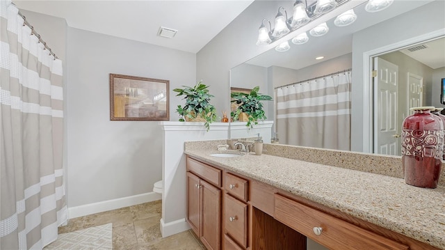 full bath with vanity, toilet, baseboards, and visible vents