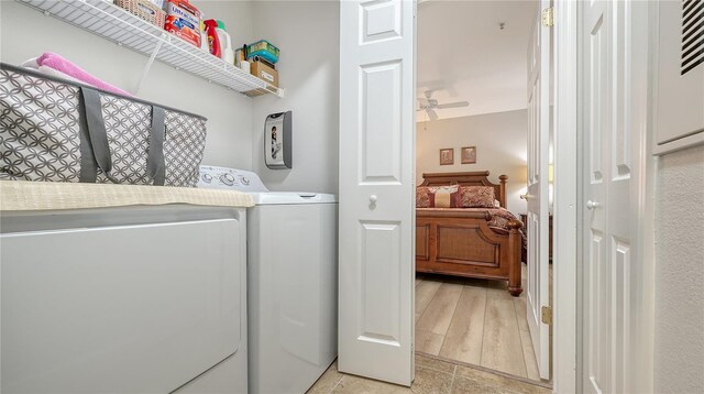 clothes washing area featuring laundry area, ceiling fan, and washer and clothes dryer