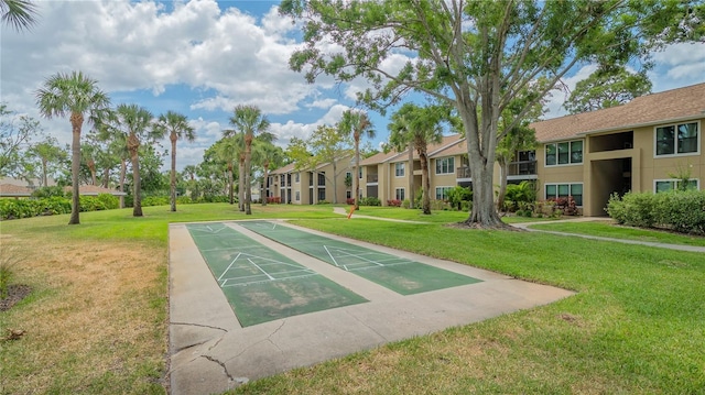 view of home's community with shuffleboard, a residential view, and a lawn
