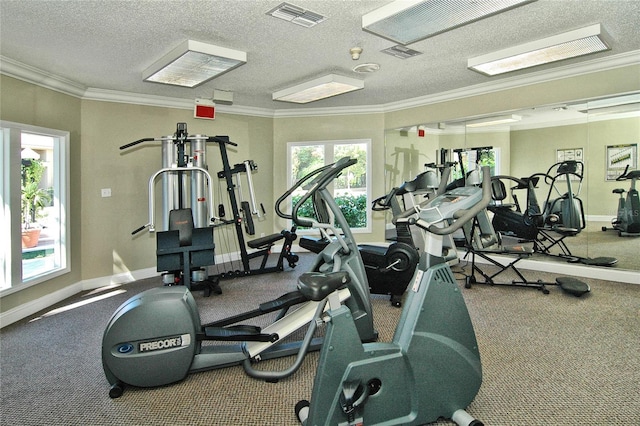 workout area with visible vents, baseboards, and a healthy amount of sunlight