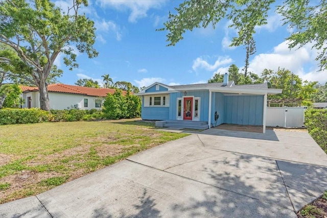 5012 Eastchester Dr, Sarasota, FL 34234 - single story home featuring a front lawn, fence, board and batten siding, driveway, and a carport