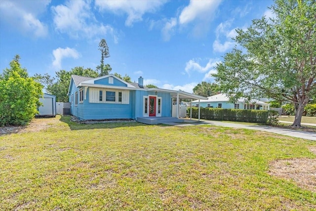 5012 Eastchester Dr, Sarasota, FL 34234 - view of front of home with fence, concrete driveway, a shed, and a front yard