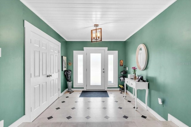 5012 Eastchester Dr, Sarasota, FL 34234 - foyer entrance with tile patterned floors, an inviting chandelier, and baseboards