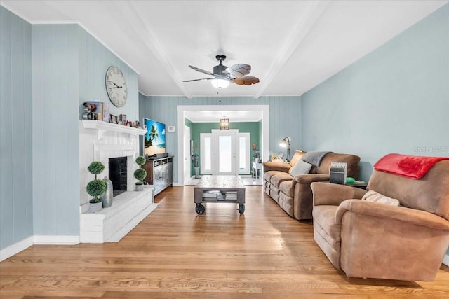 5012 Eastchester Dr, Sarasota, FL 34234 - living room with beamed ceiling, a ceiling fan, wood finished floors, and a brick fireplace
