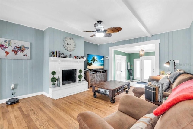 5012 Eastchester Dr, Sarasota, FL 34234 - living room featuring a ceiling fan, baseboards, a fireplace with raised hearth, and wood finished floors