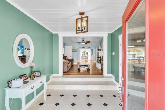 5012 Eastchester Dr, Sarasota, FL 34234 - tiled entrance foyer featuring baseboards and ceiling fan with notable chandelier