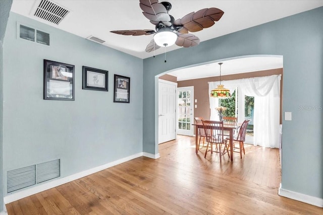 5012 Eastchester Dr, Sarasota, FL 34234 - dining room with arched walkways, baseboards, wood finished floors, and visible vents