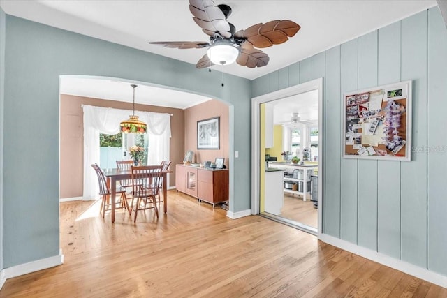5012 Eastchester Dr, Sarasota, FL 34234 - dining space with plenty of natural light, a ceiling fan, arched walkways, and light wood-type flooring