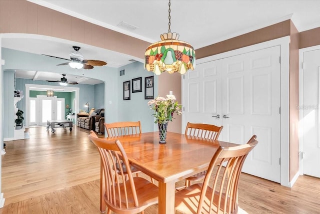 5012 Eastchester Dr, Sarasota, FL 34234 - dining room with crown molding, ceiling fan, light wood finished floors, and visible vents