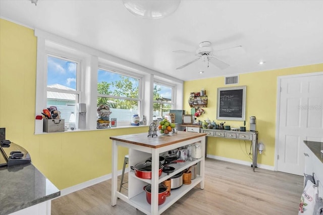 5012 Eastchester Dr, Sarasota, FL 34234 - dining area with baseboards, ceiling fan, visible vents, and light wood-style flooring