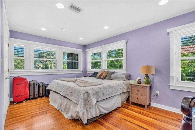 5012 Eastchester Dr, Sarasota, FL 34234 - bedroom with radiator, visible vents, multiple windows, and light wood finished floors