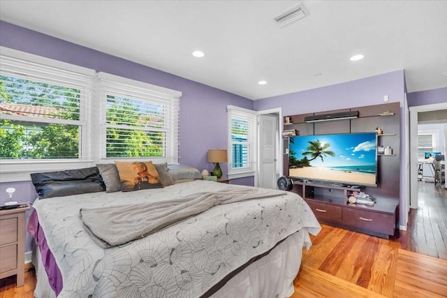 5012 Eastchester Dr, Sarasota, FL 34234 - bedroom featuring visible vents, multiple windows, and light wood-type flooring