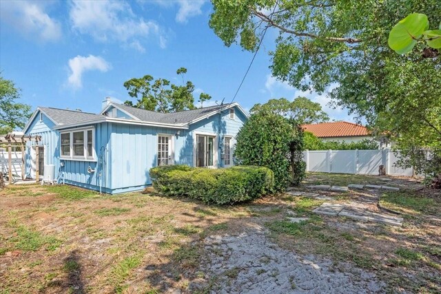 5012 Eastchester Dr, Sarasota, FL 34234 - view of home's exterior featuring board and batten siding and fence