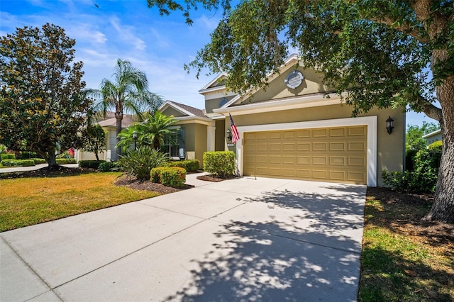 view of front facade with concrete driveway, a garage, a front lawn, and stucco siding