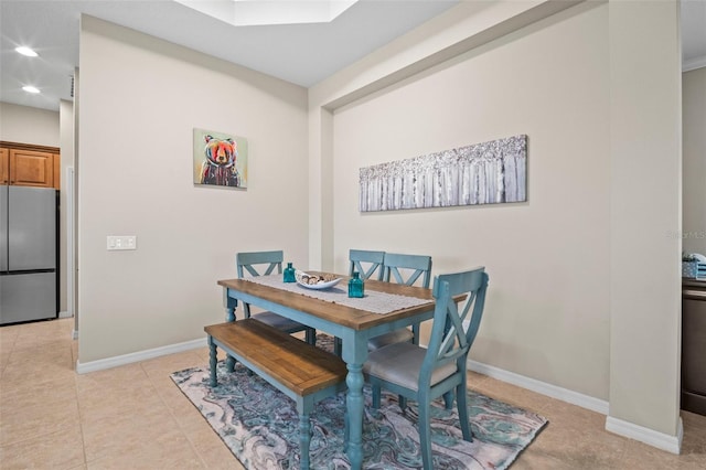 dining room featuring light tile patterned floors, baseboards, and recessed lighting