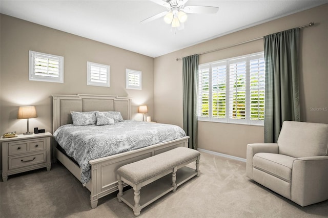 bedroom featuring a ceiling fan, baseboards, and light colored carpet