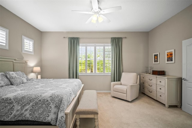 bedroom featuring a ceiling fan, baseboards, and light colored carpet
