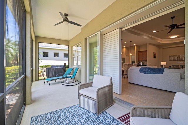sunroom featuring a ceiling fan and a healthy amount of sunlight