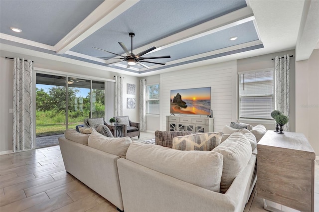 living area with baseboards, ceiling fan, and recessed lighting