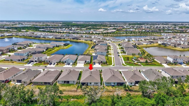 birds eye view of property featuring a water view and a residential view