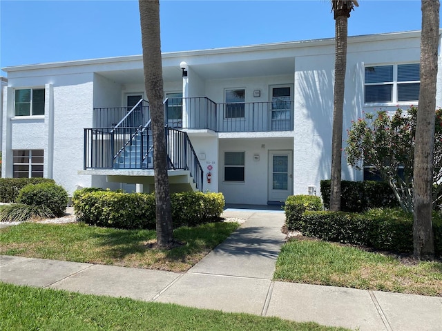townhome / multi-family property with stucco siding and stairway