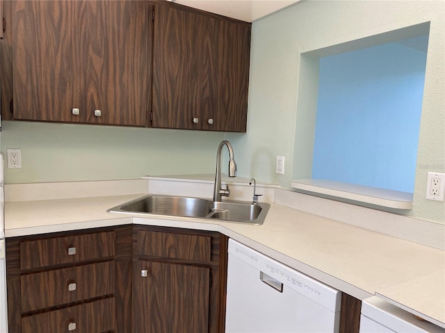 kitchen featuring a sink, white dishwasher, light countertops, and dark brown cabinets