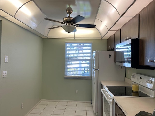 kitchen with electric range, stainless steel microwave, a ceiling fan, light countertops, and light tile patterned floors