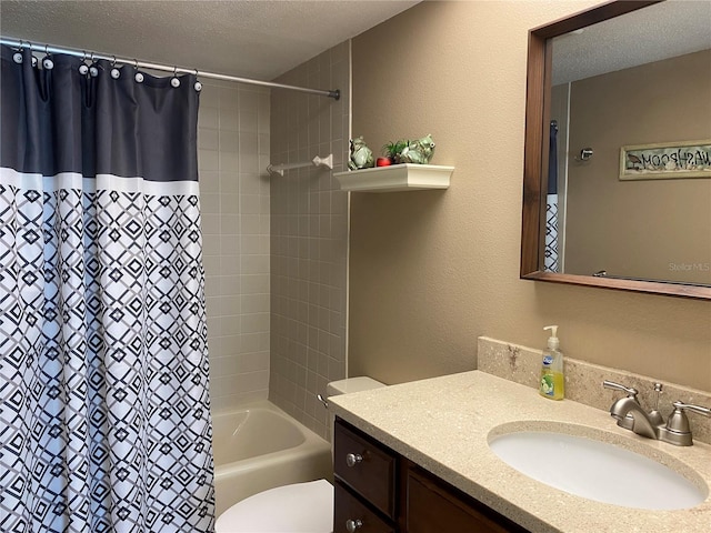 bathroom featuring vanity, shower / bath combo, toilet, and a textured ceiling