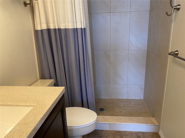 full bath featuring toilet, a shower stall, and vanity