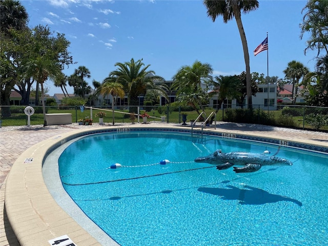 community pool featuring fence