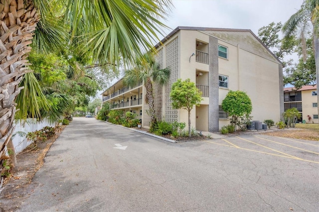 2280 Stickney Point Rd Unit 420, Sarasota, FL 34231 - view of property featuring central AC unit and uncovered parking