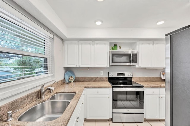 2280 Stickney Point Rd Unit 420, Sarasota, FL 34231 - kitchen with white cabinets, light stone countertops, appliances with stainless steel finishes, and a sink
