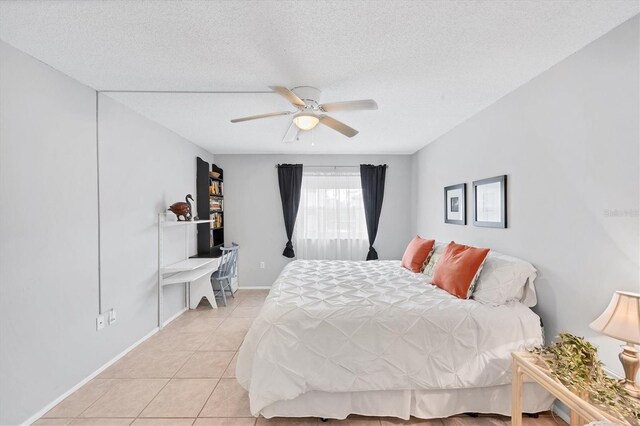 2280 Stickney Point Rd Unit 420, Sarasota, FL 34231 - bedroom featuring light tile patterned floors, a ceiling fan, and a textured ceiling