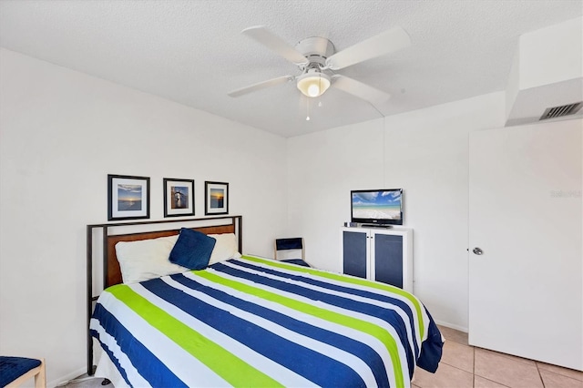 2280 Stickney Point Rd Unit 420, Sarasota, FL 34231 - bedroom featuring visible vents, a ceiling fan, a textured ceiling, and light tile patterned floors