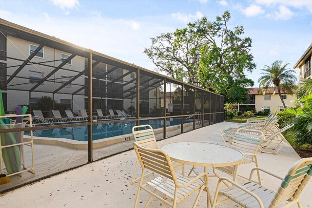 2280 Stickney Point Rd Unit 420, Sarasota, FL 34231 - view of patio with a community pool and a lanai