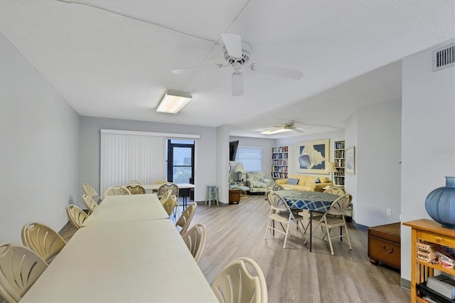 2280 Stickney Point Rd Unit 420, Sarasota, FL 34231 - dining room featuring ceiling fan, wood finished floors, and visible vents