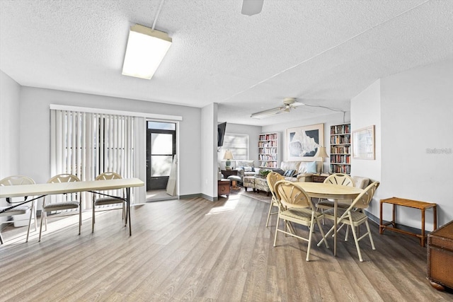 2280 Stickney Point Rd Unit 420, Sarasota, FL 34231 - dining area with baseboards, a ceiling fan, a textured ceiling, and wood finished floors