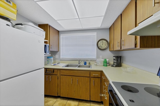2280 Stickney Point Rd Unit 420, Sarasota, FL 34231 - kitchen featuring freestanding refrigerator, stainless steel microwave, under cabinet range hood, a sink, and range