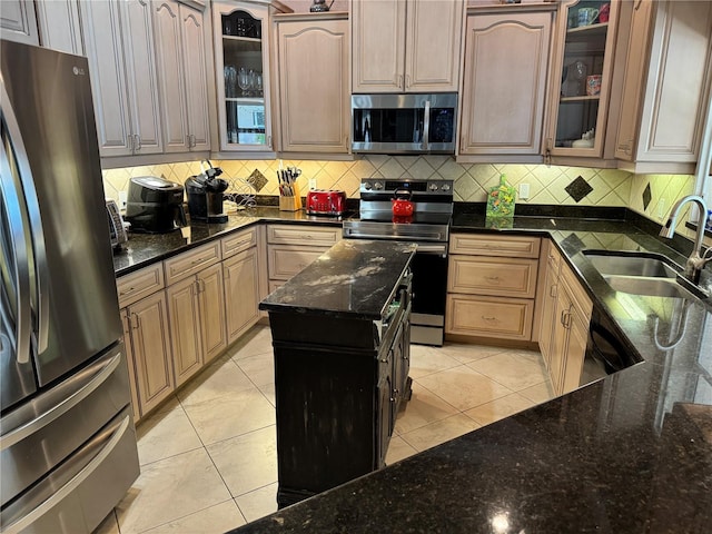 652 N Elm St, Englewood, FL 34223 - kitchen featuring appliances with stainless steel finishes, a sink, decorative backsplash, and dark stone counters