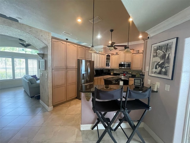652 N Elm St, Englewood, FL 34223 - kitchen featuring appliances with stainless steel finishes, a ceiling fan, ornamental molding, tasteful backsplash, and a breakfast bar