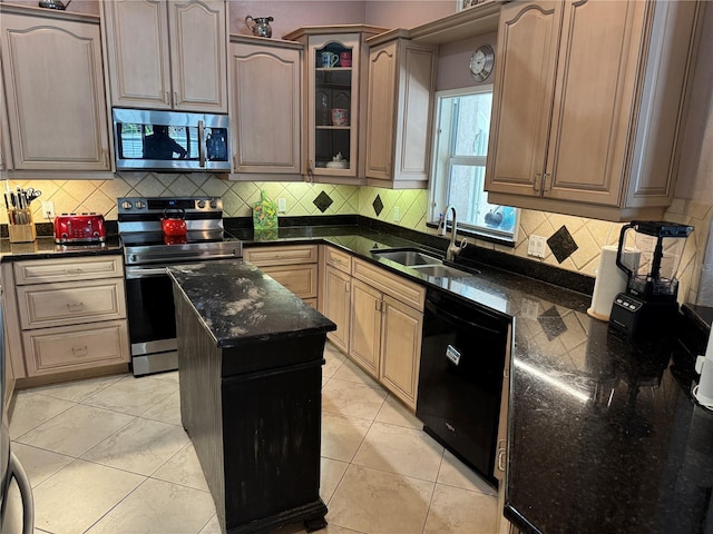 652 N Elm St, Englewood, FL 34223 - kitchen with appliances with stainless steel finishes, a sink, dark stone counters, and tasteful backsplash