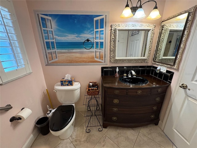 652 N Elm St, Englewood, FL 34223 - bathroom featuring vanity, toilet, a chandelier, baseboards, and a water view