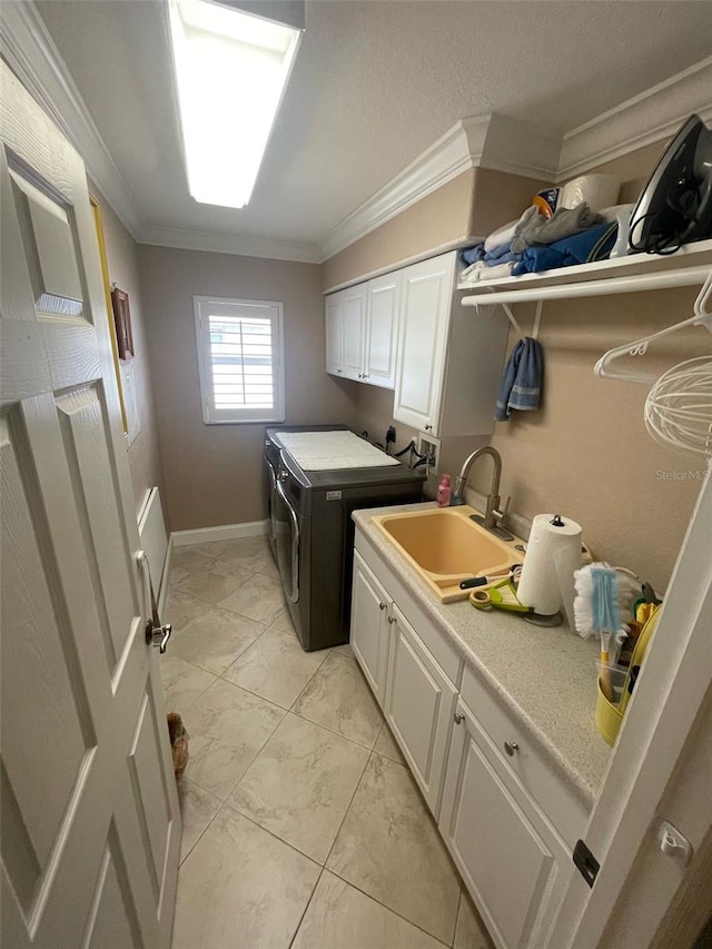 652 N Elm St, Englewood, FL 34223 - washroom featuring washing machine and dryer, cabinet space, ornamental molding, and baseboards