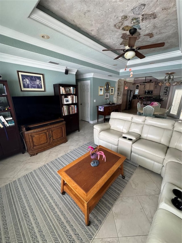 652 N Elm St, Englewood, FL 34223 - living room featuring a raised ceiling, a ceiling fan, light marble finish floors, ornamental molding, and baseboards