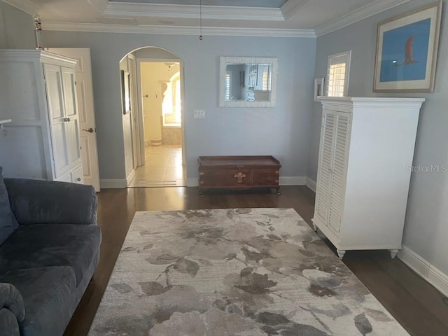 652 N Elm St, Englewood, FL 34223 - living room featuring arched walkways, wood finished floors, crown molding, baseboards, and a raised ceiling