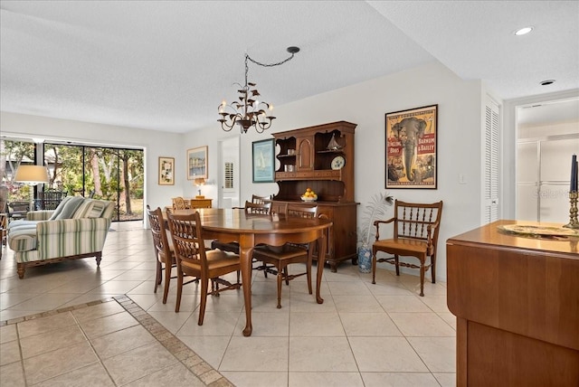 dining room with light tile patterned floors, a chandelier, recessed lighting, and a textured ceiling