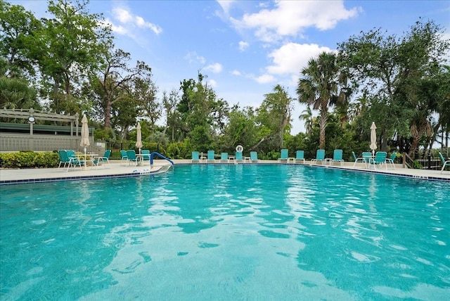 pool featuring fence and a patio