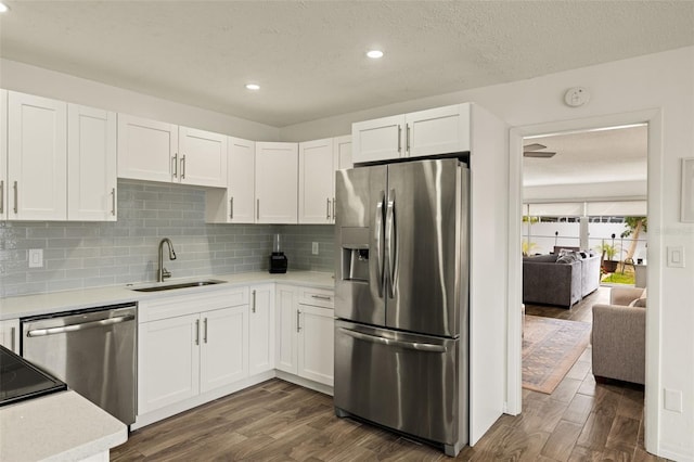 1458 Alwynne Dr N, Lehigh Acres, FL 33936 - kitchen with light countertops, appliances with stainless steel finishes, a sink, and dark wood finished floors