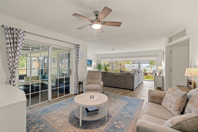 1458 Alwynne Dr N, Lehigh Acres, FL 33936 - living area with a ceiling fan, a textured ceiling, and wood finished floors