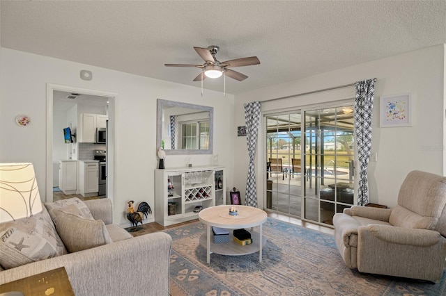 1458 Alwynne Dr N, Lehigh Acres, FL 33936 - living area featuring a ceiling fan, a textured ceiling, and visible vents